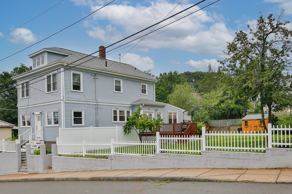 26 Foss Street, Unit 1 Medford, MA 02155 - Photo 2 of 35 a front view of a house with a garden and plants