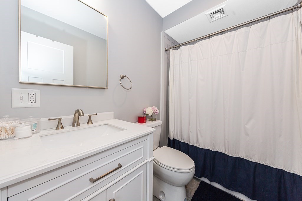 26 Foss Street, Unit 1 Medford, MA 02155 - Photo 27 of 35 a bathroom with a sink a toilet and a mirror
