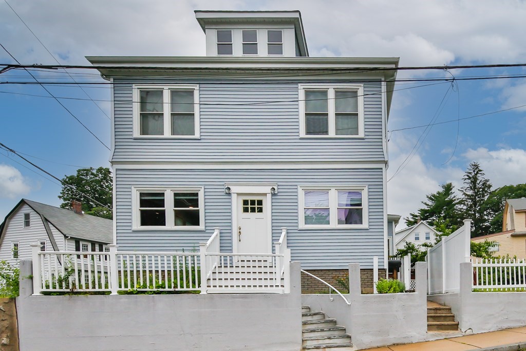 26 Foss Street, Unit 1 Medford, MA 02155 - Photo 3 of 35 a front view of a house with a porch