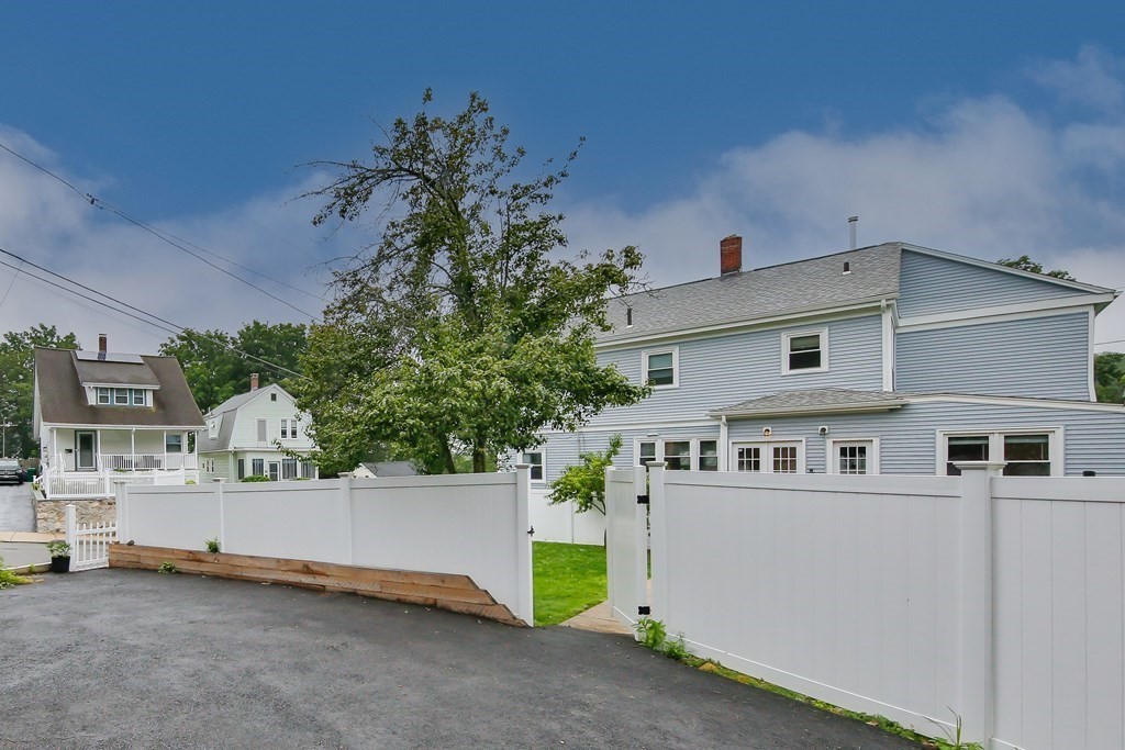 26 Foss Street, Unit 1 Medford, MA 02155 - Photo 35 of 35 a view of a house with a fence and a tree