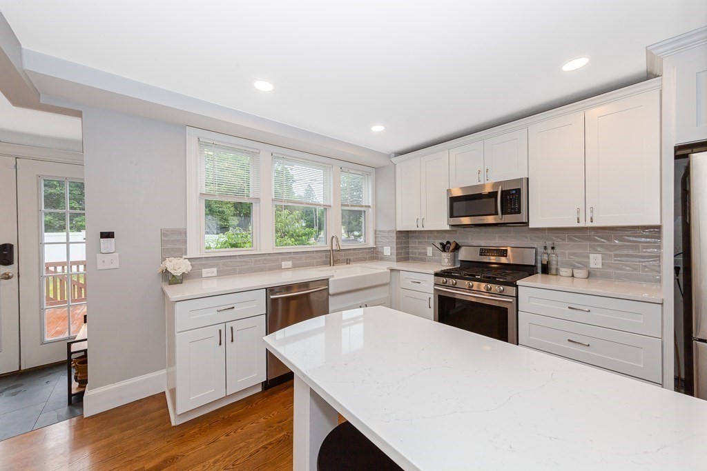 26 Foss Street, Unit 1 Medford, MA 02155 - Photo 5 of 35 a kitchen with a stove a sink and a microwave