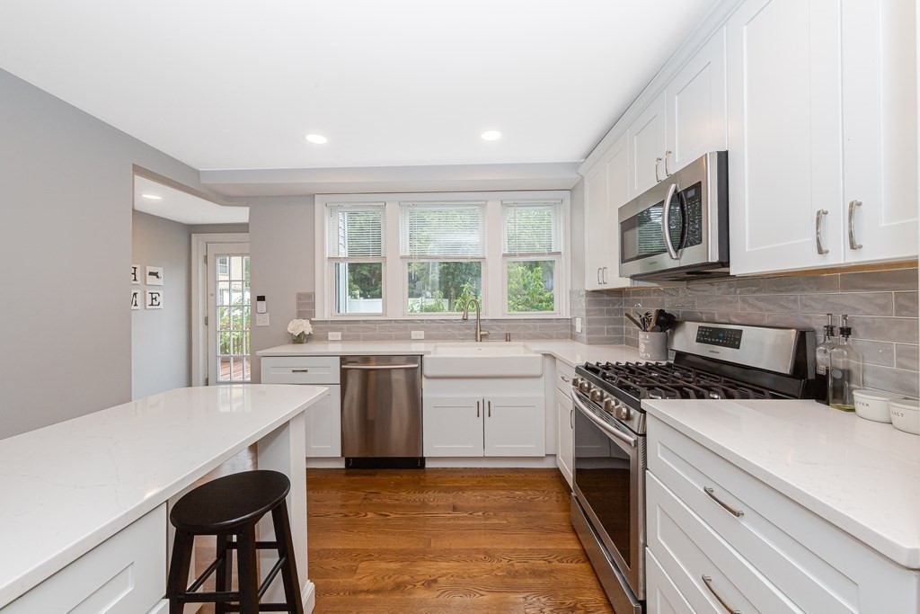 26 Foss Street, Unit 1 Medford, MA 02155 - Photo 8 of 35 a kitchen with a stove a sink and a refrigerator
