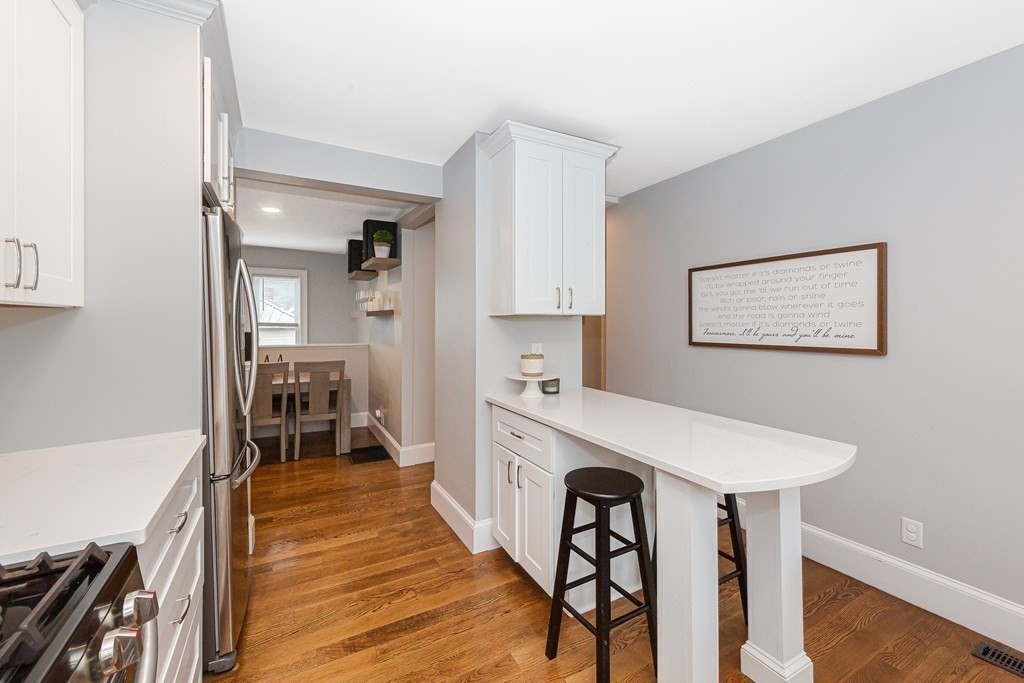 26 Foss Street, Unit 1 Medford, MA 02155 - Photo 9 of 35 a large white kitchen with sink and cabinets