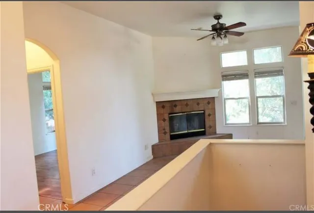 a view of an empty room with a fireplace and a window