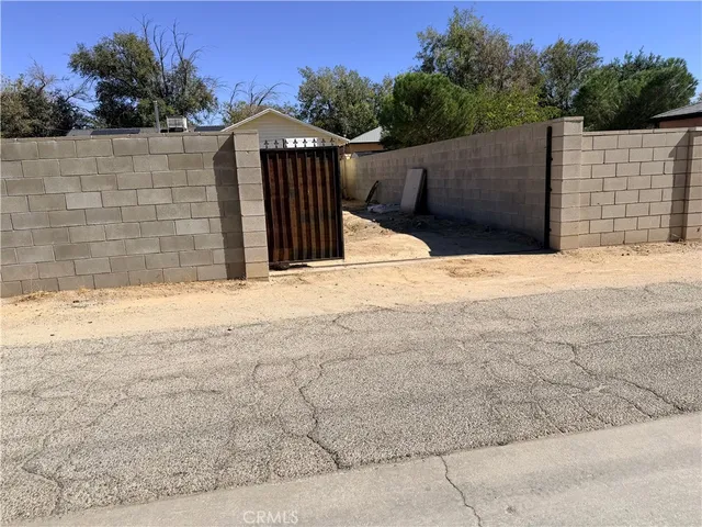 a view of wooden fence next to a yard