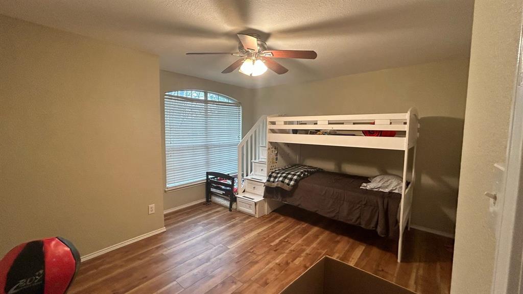 116 Lightning Trail Forney, TX 75126 - Photo 14 of 19 a bedroom with a bed and a chandelier