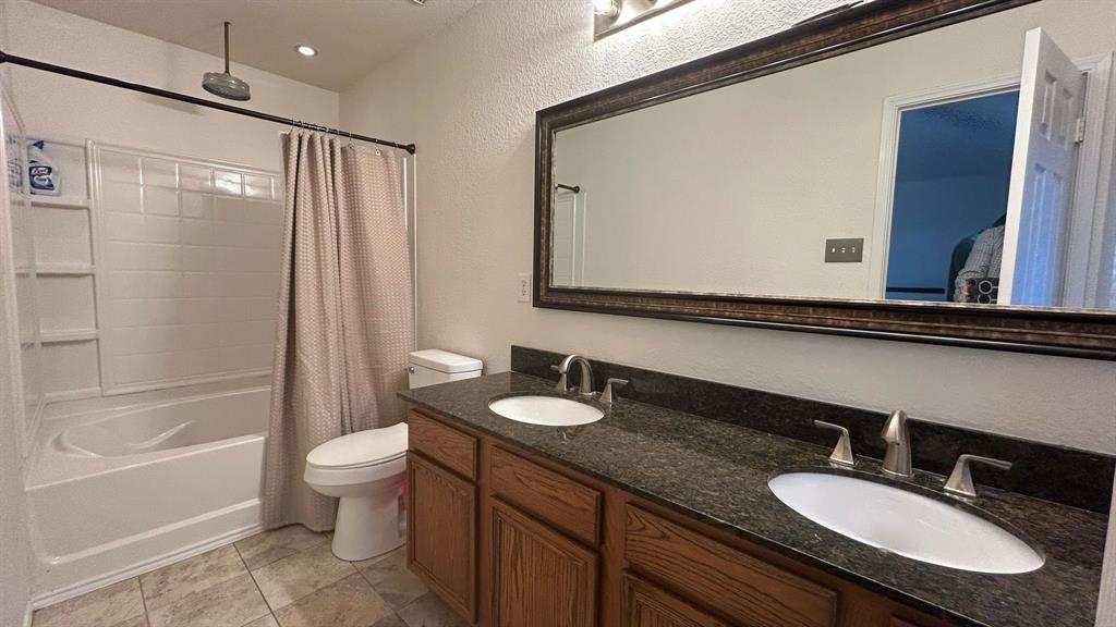116 Lightning Trail Forney, TX 75126 - Photo 15 of 19 a bathroom with a granite countertop sink and a mirror