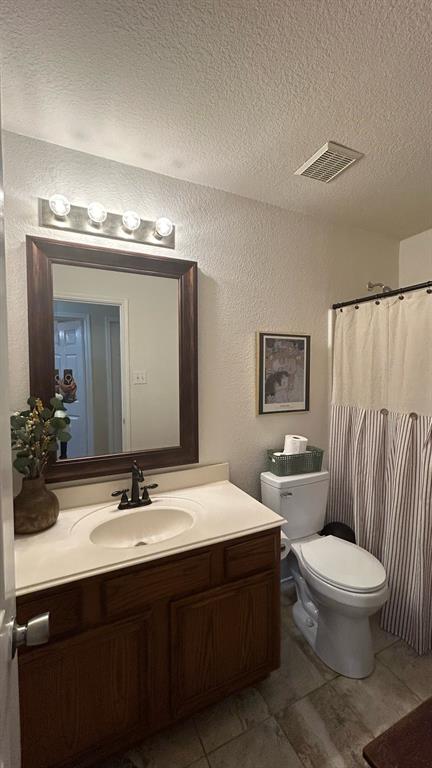 116 Lightning Trail Forney, TX 75126 - Photo 16 of 19 a bathroom with a double vanity sink toilet and a mirror