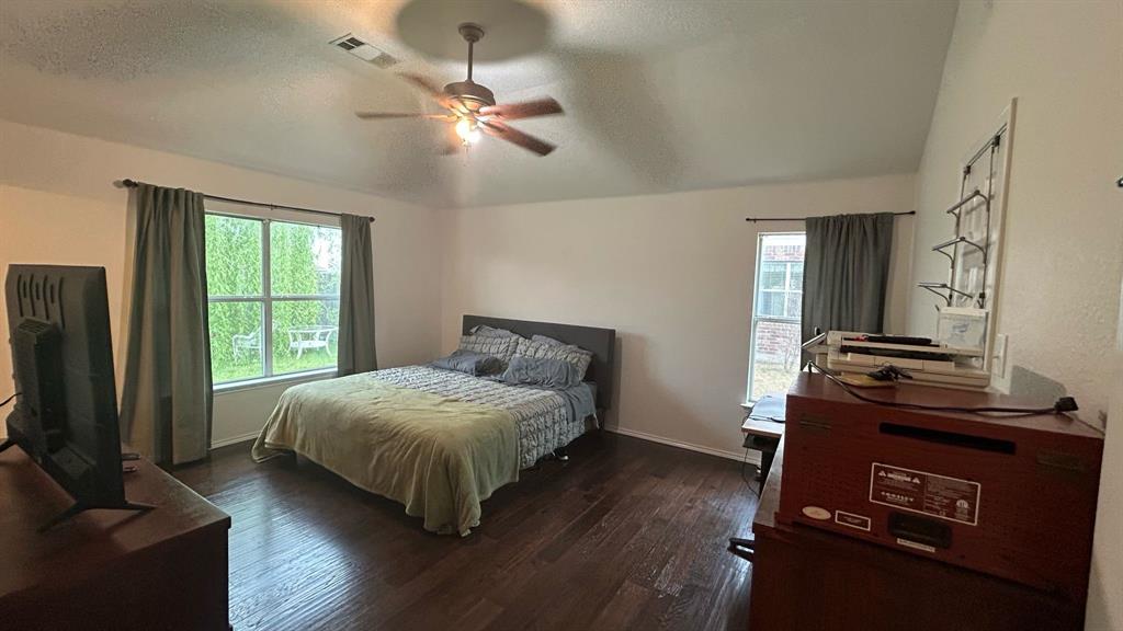 116 Lightning Trail Forney, TX 75126 - Photo 17 of 19 a bedroom with a bed and wooden floor