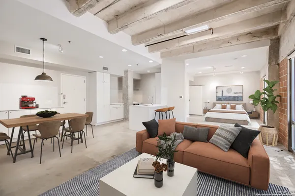 a living room with furniture and wooden floor