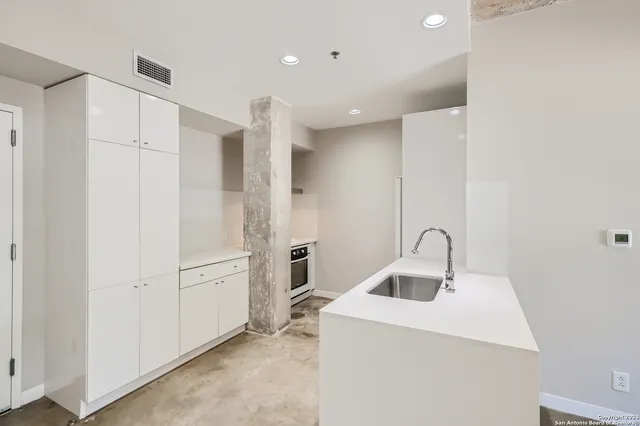 a view of open kitchen with a sink and large window