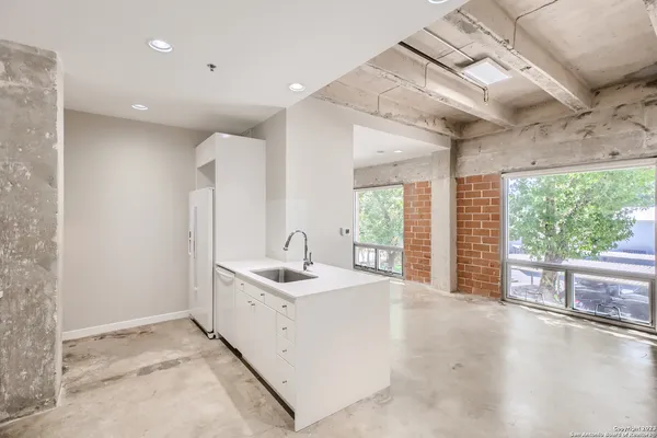 a kitchen with stainless steel appliances a sink and a refrigerator
