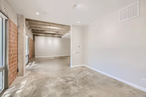 a view of an empty room with a fireplace