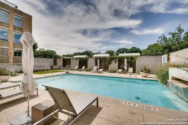 a view of a house with backyard patio and swimming pool