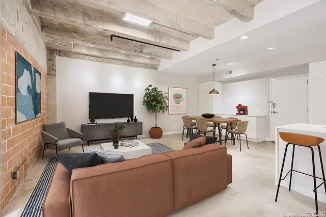 a living room with furniture and a flat screen tv