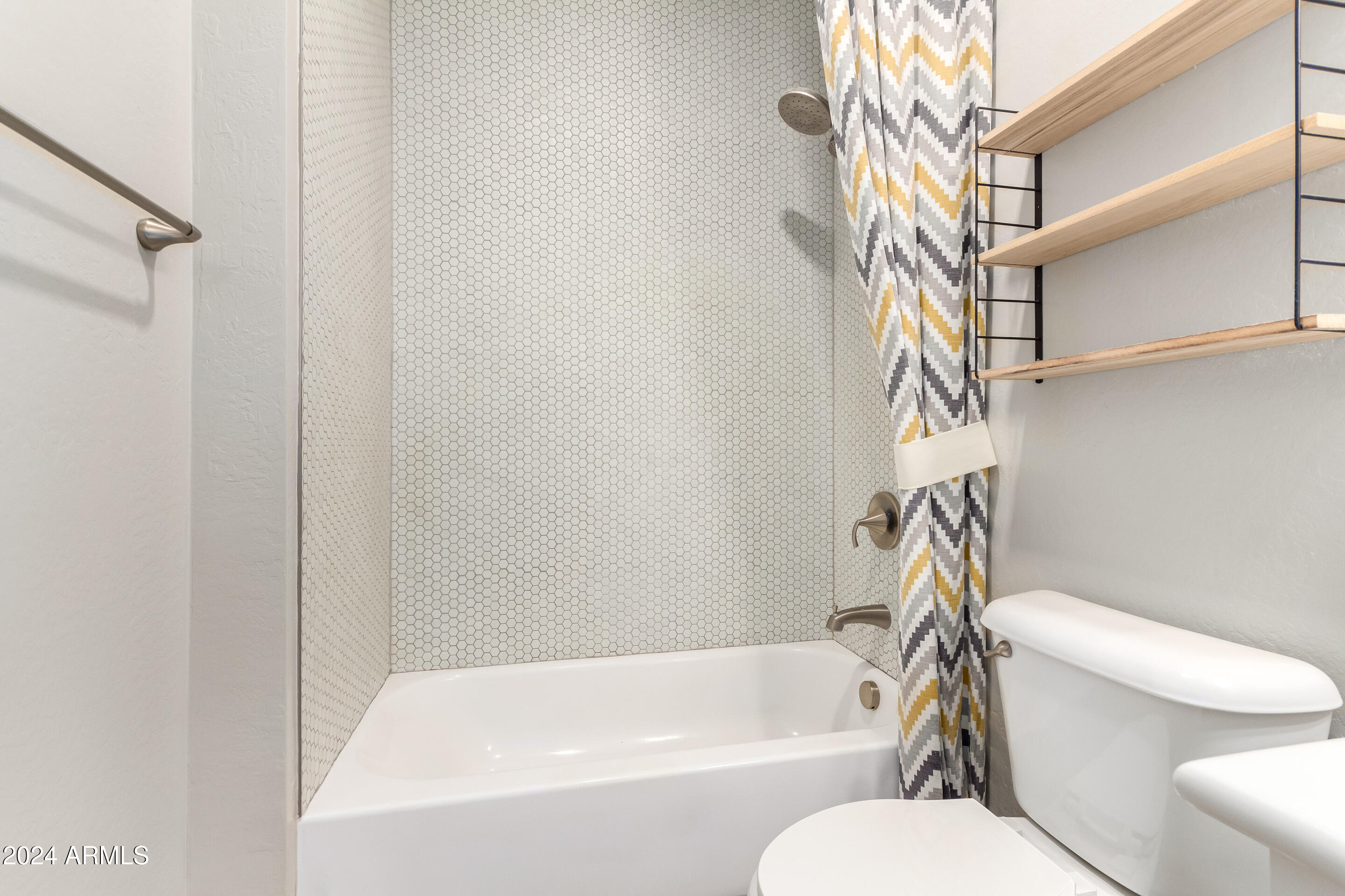 3900 East Baseline Road, Unit 177 Phoenix, AZ 85042 - Photo 32 of 41 a bathroom with a toilet and a bathtub