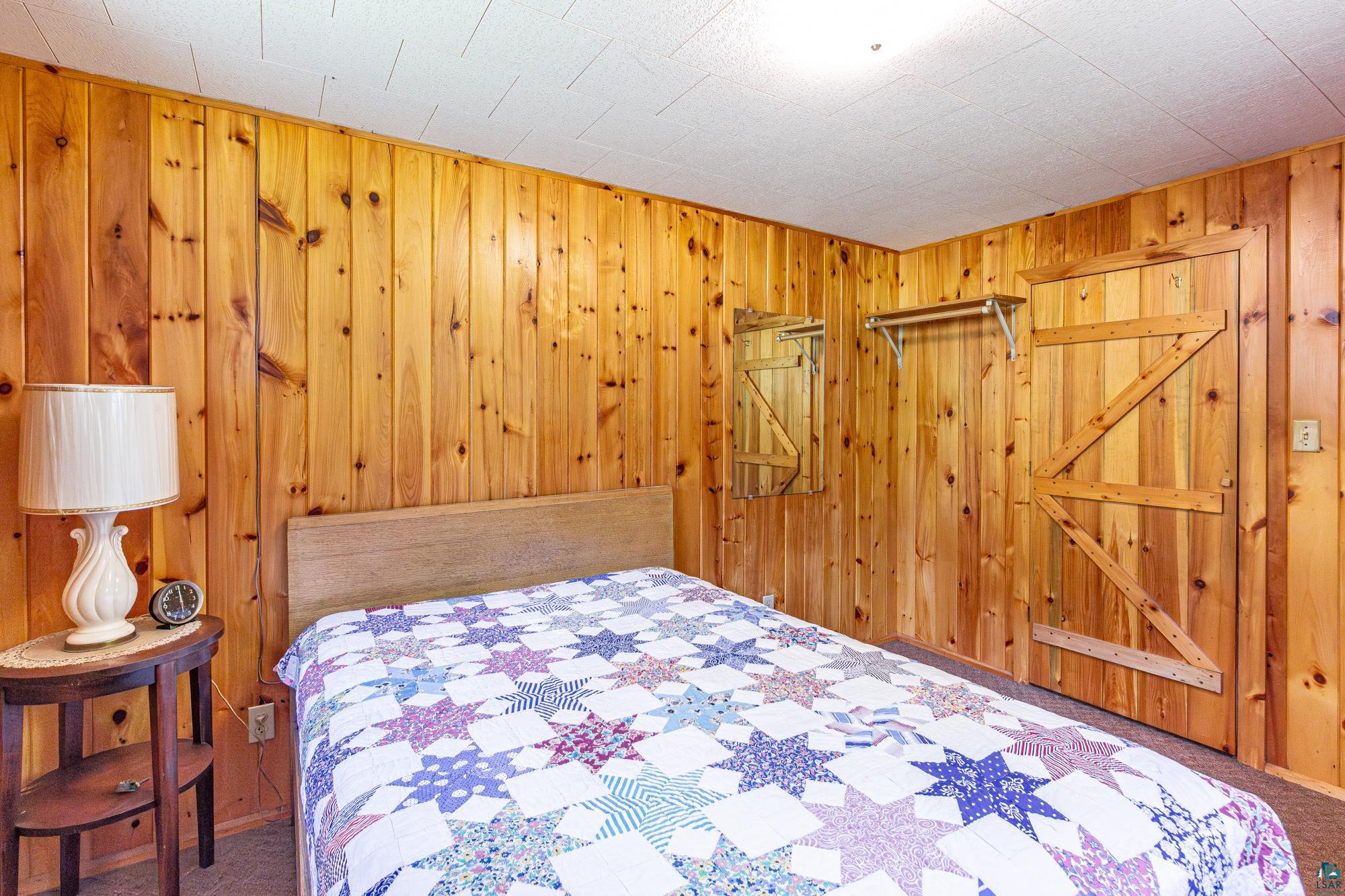 2823 Moroni Point Road Ely, MN 55731 - Photo 3 of 49 Carpeted bedroom with wooden walls