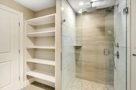 a bathroom with a glass shower door
