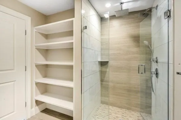 a bathroom with a glass shower door