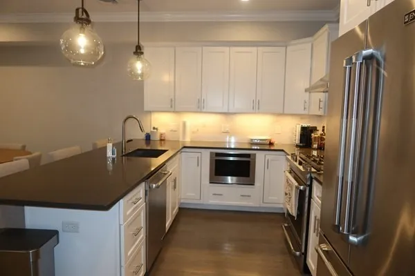 a kitchen with a sink a stove and cabinets