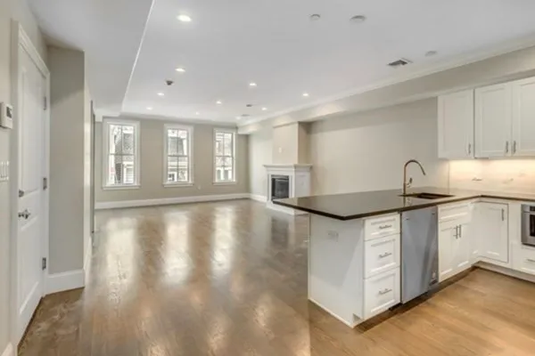 a kitchen with stainless steel appliances granite countertop a sink and a stove top oven