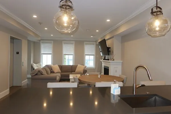 a large living room with furniture and a chandelier