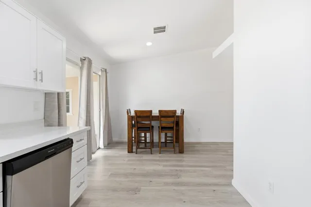 a dining room with furniture and wooden floor