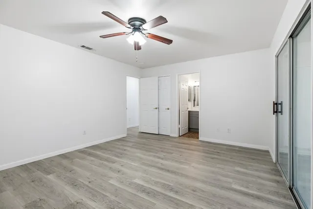a view of an empty room with wooden floor