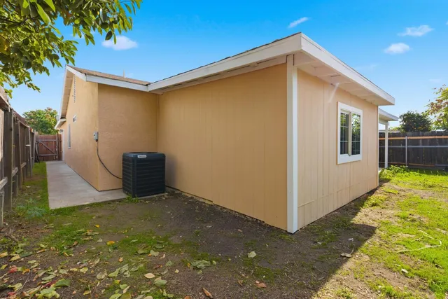 a backyard of a house with barbeque oven