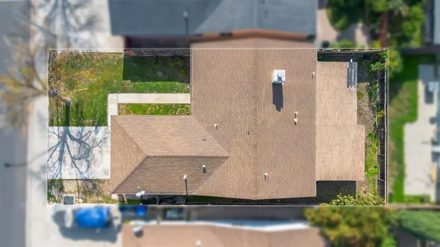 an aerial view of a house with a yard