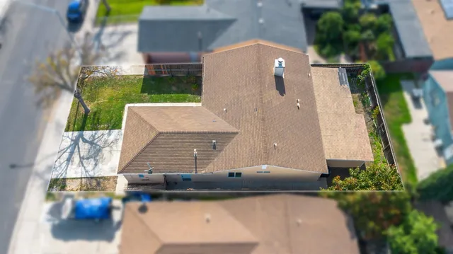 an aerial view of a house with a yard