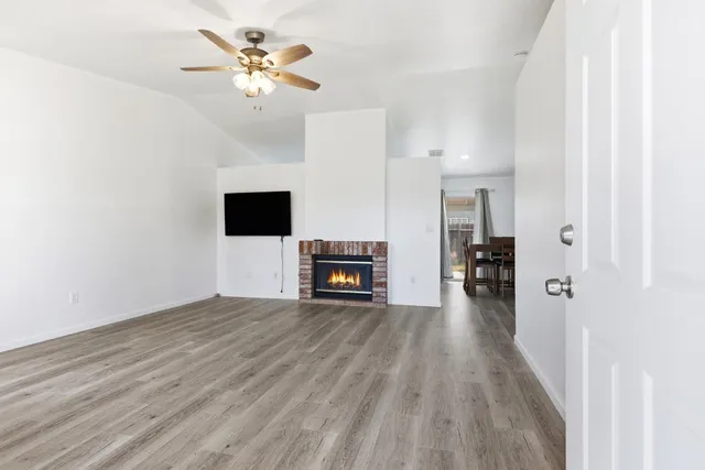 a view of a livingroom with a flat screen tv and a ceiling fan