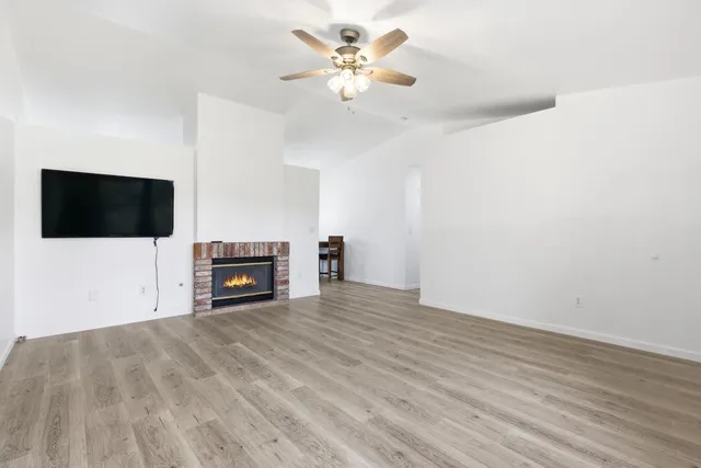 a view of a livingroom with a flat screen tv and ceiling fan