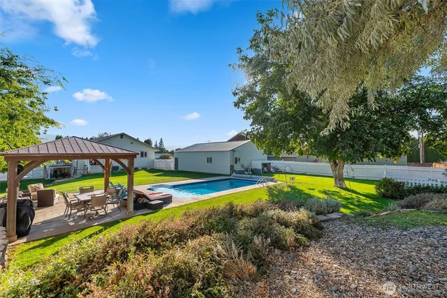 a view of a swimming pool with lounge chairs