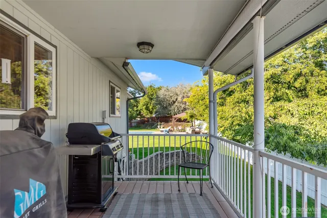 a view of a porch with furniture and garden