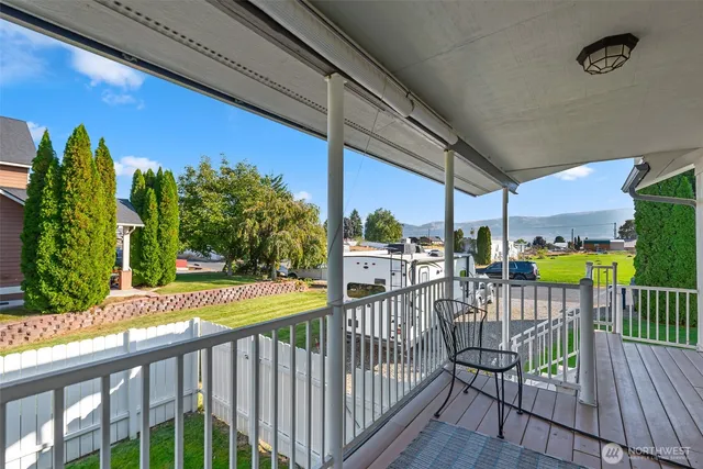 a view of a balcony with wooden floor