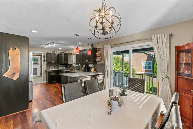 a kitchen with a table chairs stove and refrigerator