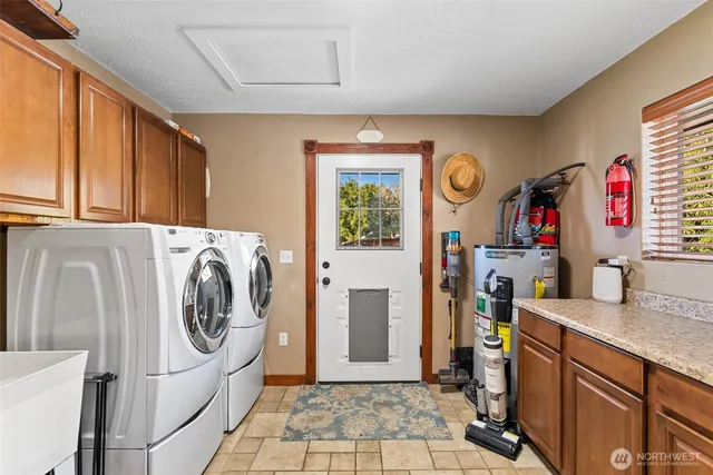 a utility room with sink dryer and washer