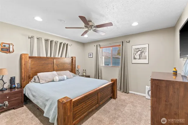 a bedroom with a large bed and a chandelier