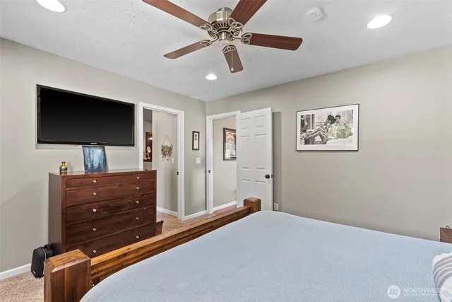 a bedroom with a bed and a flat screen tv