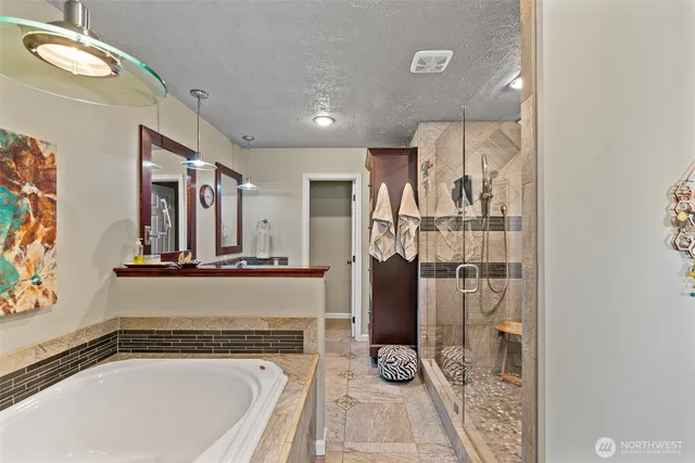 a view of a bathroom with a tub and shower