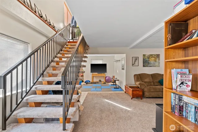 a living room with furniture and stairs