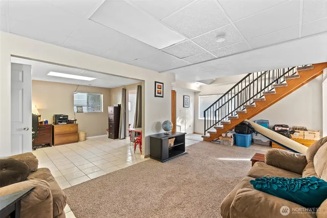 a living room with furniture stairs and a chandelier