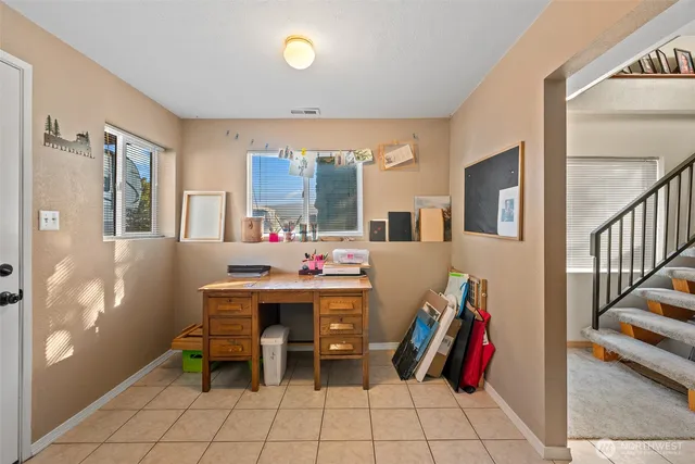 a view of a workspace with furniture and entryway