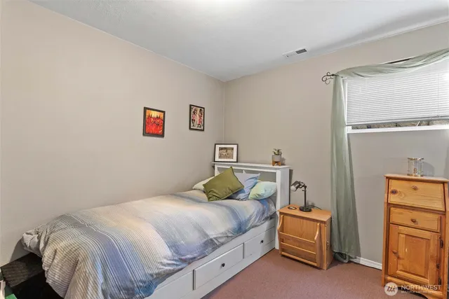 a bedroom with a bed and a dresser