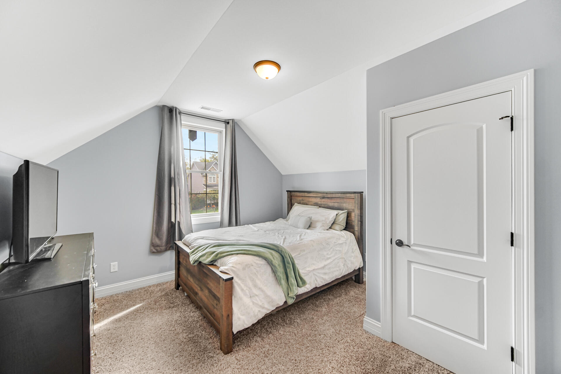 12566 Massachusetts Street Crown Point, IN 46307 - Photo 16 of 30 a bedroom with a bed and a flat screen tv