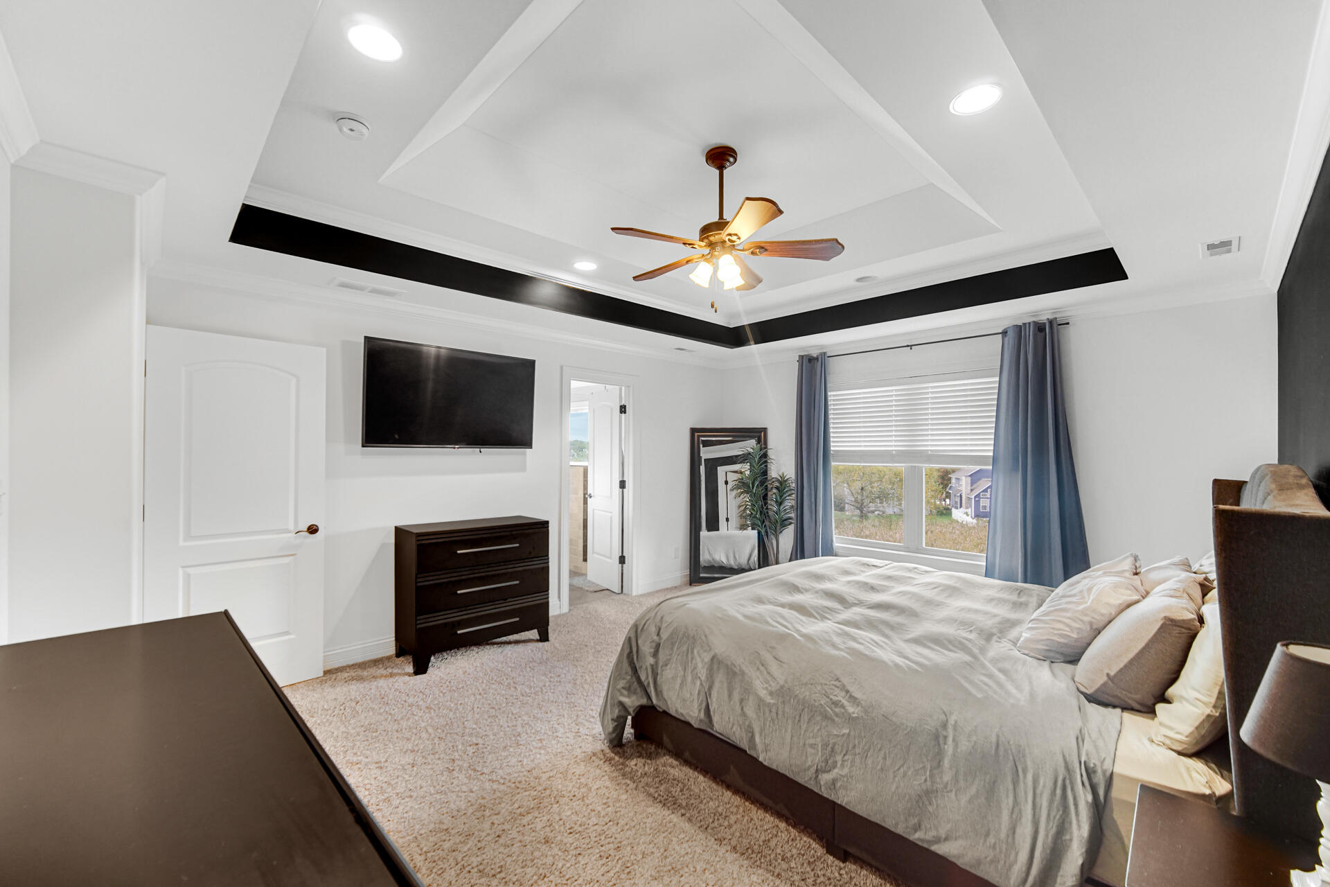 12566 Massachusetts Street Crown Point, IN 46307 - Photo 10 of 30 a bedroom with a bed and a flat screen tv