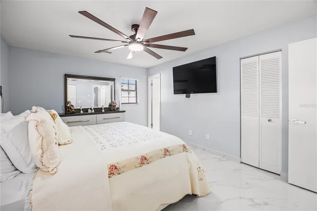 a bedroom with a bed and a flat screen tv