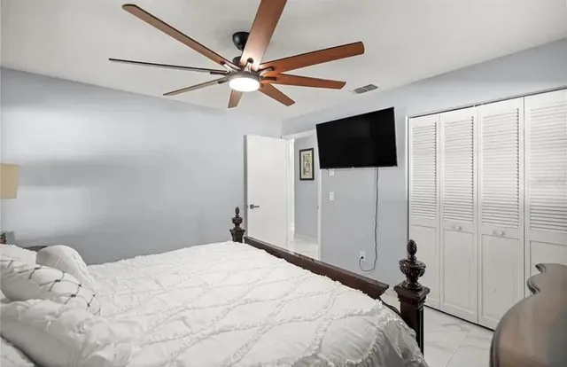 a bedroom with a bed and a flat screen tv