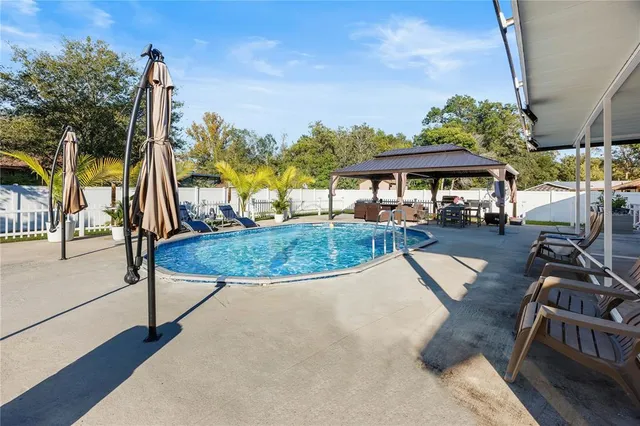 a view of a swimming pool with a patio